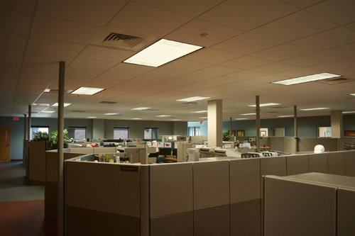 A dimly lit office building with old fluorescent lighting