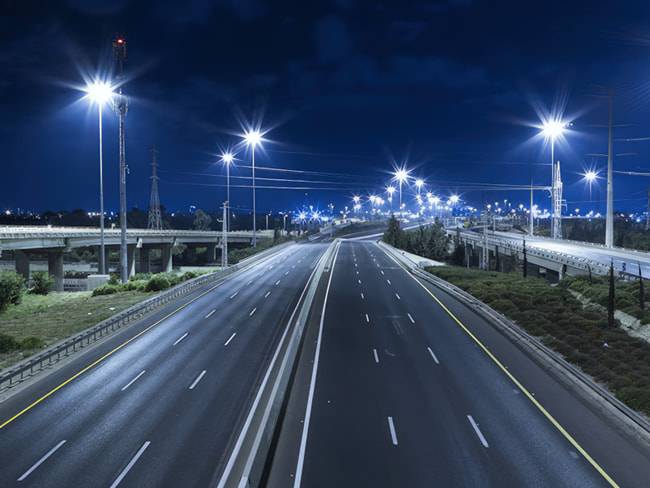 Bright LED street lights illuminating a highway within the city limits of a municipality