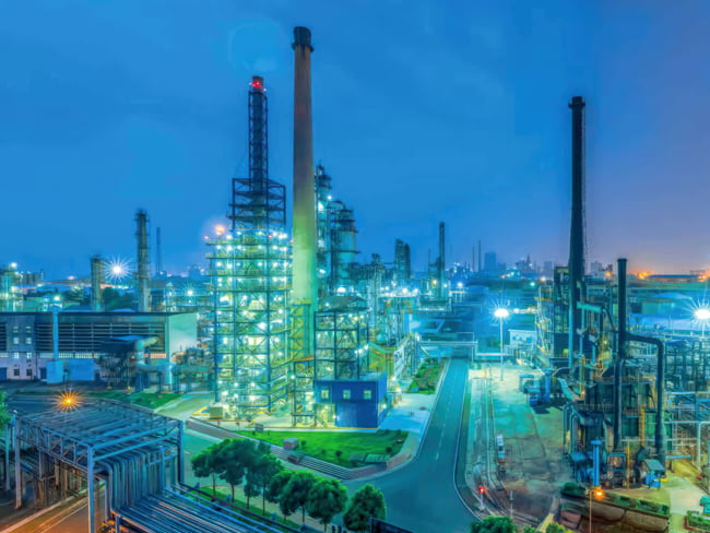 Large petrochemical facility with bright LED lights illuminating the exterior showing. These lights are specialized for the oil and gas industry