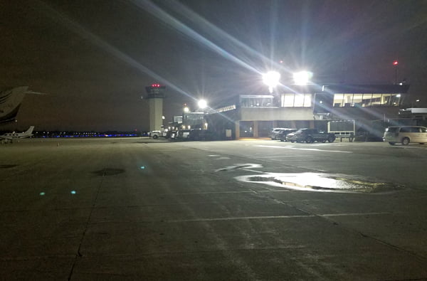 High power LED flood lights casting bright illumination onto a airport parking lot from the control tower