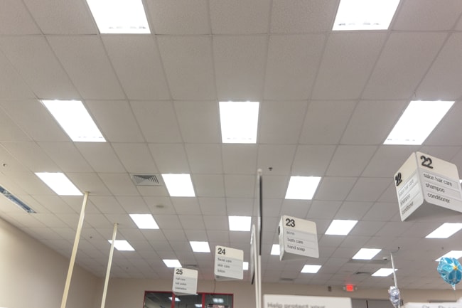 Square shaped LED troffer lights on the ceiling inside a pharmacy